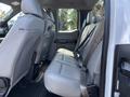 Interior view of the rear seats of a 2016 Ford F-150 with leather upholstery and seat belts visible