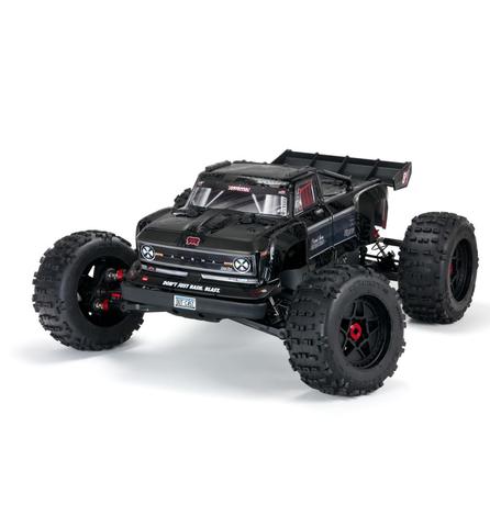 A black Arrma 1/5 Outcast 8S EXB 4X4 roller brushless stunt truck with large tires and aggressive styling designed for off-road performance