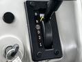 Close-up of the gear shifter in a 2015 Spartan School Bus showing positions for reverse neutral and drive