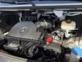 The engine compartment of a 2023 Mercedes-Benz Sprinter featuring the engine cover with the Mercedes-Benz star logo and various engine components