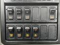 Dashboard switches of a 2013 International DuraStar including controls for diff lock dump PTO and various lights