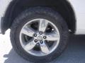 A close-up view of a silver alloy wheel with five spokes mounted on a rugged tire, part of a 2019 RAM 1500 Classic Eco Diesel vehicle