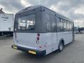 A gray 2016 Chevrolet Express bus viewed from the rear with large windows and rear lights