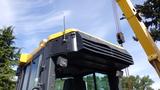 A 2013 Komatsu D37PX-22 bulldozer with a yellow and gray color scheme featuring a flat hood and front lights