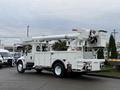 A white 2007 International 4200 truck equipped with a bucket lift and tool compartments on the sides