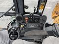 The control panel of a 2011 John Deere 310SJ 4x4 Wheel Loader Extended Hoe with various levers switches and gauges in the operator's cabin