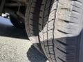 Close-up of a Chevrolet Express tire showing deep tread patterns and slight wear on the rubber surface