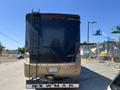 A 2008 Newmar Canyon Star 36 Foot Class A Motorhome featuring a black and tan exterior with a rear ladder and tinted rear windows