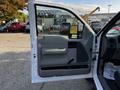 Interior view of the driver's side door of a 2008 Ford F-150 XL featuring a gray panel and handle with controls for window operation