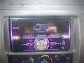 A Pioneer car stereo with a purple display showing the time as 9:49 AM and various controls for audio settings