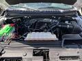 A 2016 Ford F-150 engine with visible components including the air intake manifold battery and coolant reservoir