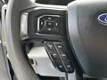 Close-up of the steering wheel controls on a 2020 Ford F-350 Super Duty featuring buttons for adjusting settings and cruise control functions