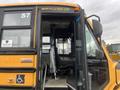 2007 Freightliner B2 school bus with an open door revealing the driver's seat and dashboard inside