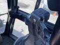 Close-up of the control lever in a 2011 Case 570 MXT tractor interior showcasing a black ergonomic handle and hybrid design
