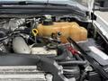 A 2008 Ford F-550 engine showing various components including hoses a yellow coolant reservoir and electrical connections