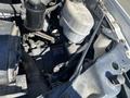 A 2020 Chevrolet Express engine compartment showcasing various components including the battery coolant reservoir and hoses