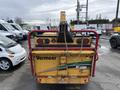 A yellow Vermeer Corporation BC1200XL chipper with a red frame and visible branding on the side