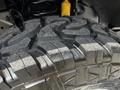 Close-up of a rugged tire tread on a 2017 Ford F-250 SD highlighting its deep grooves and aggressive design for off-road performance