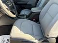 The interior of a 2018 GMC Canyon showing the driver's side seat in light gray upholstery and the steering wheel with controls visible