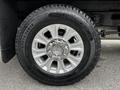 Close-up of a silver alloy wheel with a large tire labeled Long Road on a 2020 Ford F-350 SD