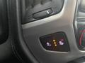 A control panel in a 2015 GMC Sierra 1500 showing buttons for heated and ventilated seats with illuminated indicators