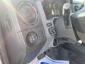 The interior of a 2015 Ford F-450 SD showing the steering wheel gear shift and various control knobs and buttons on the dashboard