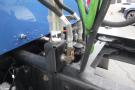 A close-up of the hydraulic system of a 2015 Kenworth T660 showing valves and connected hoses in various colors