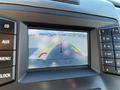 Close-up of a rearview camera display in a 2014 Ford F-150 showing parking guidelines with red yellow and green lines