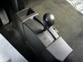 A close-up of the gear shift lever in a 2017 GMC Sierra 1500 featuring four-wheel drive mode indicators 2H N 4H and a black knob for shifting