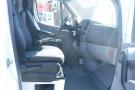 Interior view of a 2012 Mercedes-Benz Sprinter showing the driver's and passenger's seats and dashboard elements