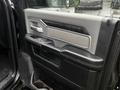 Interior door panel of a 2020 RAM 3500 featuring handles controls and a textured surface