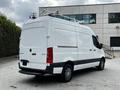 A 2020 Mercedes-Benz Sprinter van in white with a sleek design and a roof rack parked at an industrial location
