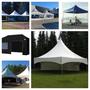 Several large tents in various styles and colors including white peak tents and a black tent suitable for events or parties