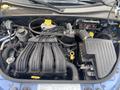Engine compartment of a 2007 Chrysler PT Cruiser showing various components like the air intake manifold battery and fluid reservoirs