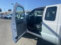 A white 2014 Ford F-250 SD with an open driver's side door showing the interior and seating area