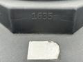 Close-up of a 2016 Peterbilt 348 vehicle identification number plate with embossed numbers and a partially torn label