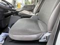 A gray fabric seat inside a 2008 International CityStar with armrests and a console between the driver and passenger seats