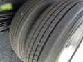 A close-up of the tires of a 2020 Hino 155 showcasing the tread patterns and rubber surfaces with three tires stacked closely together