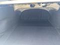 A spacious trunk of a 2017 Acura TLX with a flat, dark carpeted floor and no visible items inside