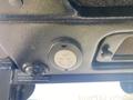 A ceiling-mounted light fixture with six LED bulbs inside a circular housing on the interior of a vehicle