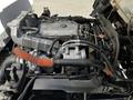 A close-up view of a 2007 GMC W3500 engine showcasing various components such as hoses intake manifold and a compressor
