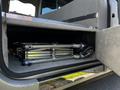 A 2013 Lincoln MKT with a neatly folded metal wheelchair ramp stored in the compartment near the rear of the vehicle