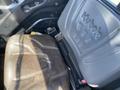 The interior of a 2018 Kubota RTV-X 1100 C featuring a brown seat with the Kubota logo embossed on the backrest