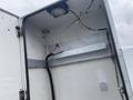 A 2003 Ford F-450 SD showing an open rear door with visible interior features including wiring and a light fixture