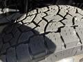 Close-up view of a heavily treaded tire from a 2012 Ford Econoline E-450 showcasing its rugged surface and deep grooves