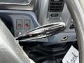 A close-up of the control stalk inside a 2006 Hino 268 featuring various settings for windshield wipers and turn signals