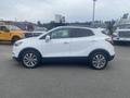 A 2018 Buick Encore is shown in profile with a white exterior and chrome wheels
