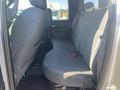 Interior view of the back seat of a 2021 RAM 1500 truck featuring cloth seating with ample legroom and a simple design