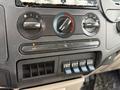 Interior dashboard controls of a 2008 Ford F-550 featuring knobs for temperature and fan speed along with buttons for air conditioning and heater functions