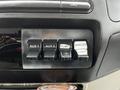 A close-up of the switch panel in a 2008 Ford F-450 SD featuring five buttons labeled AUX 1 AUX 2 PUMP SANDER and LIGHT